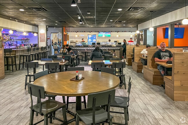 Diners enjoy Japanese cuisine at Sushi Kin, just a short drive from Downtown Riverfront.