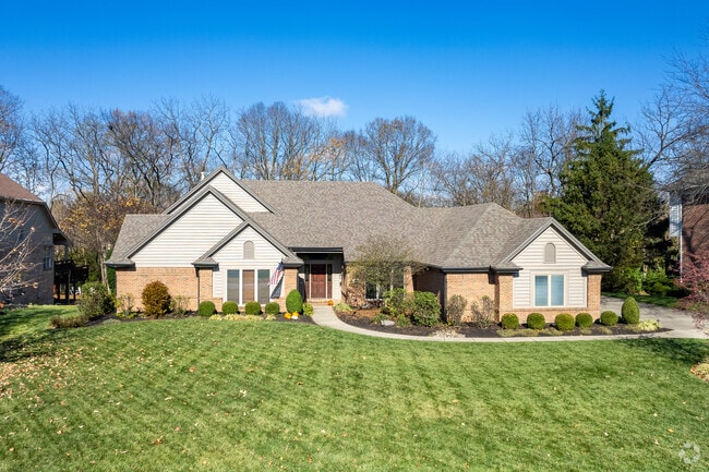 A modern ranch-style home in Clearcreek Township features beautiful landscaping.