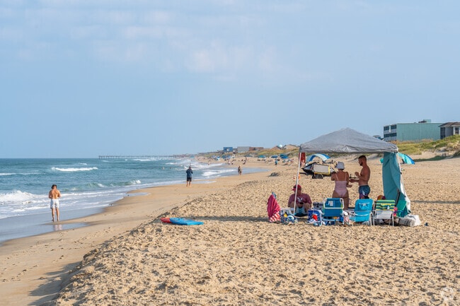 Families relax in the shade on a hot summer afternoon at Whalebone Beach.