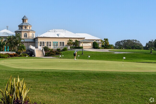 Amidst the serene surroundings, a golfer hones their putting skills on the putting green.