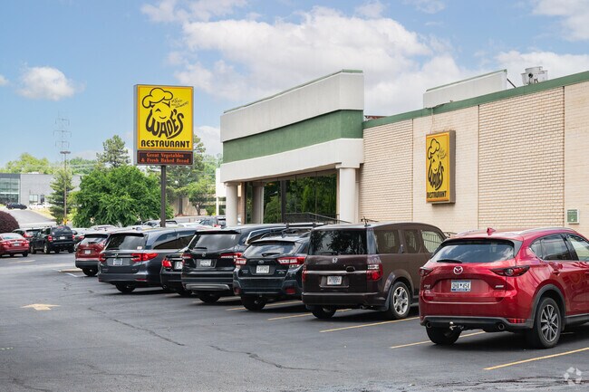 A row of cars parked outside Wade's Restaurant.