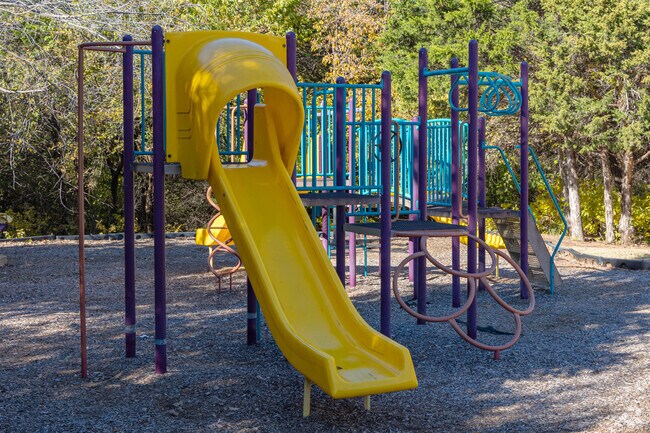 Children slide down play equipment at Hawks Landing playground in Covell-Danforth.