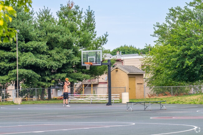 Locals practice their shot on the courts at Temple Playground.