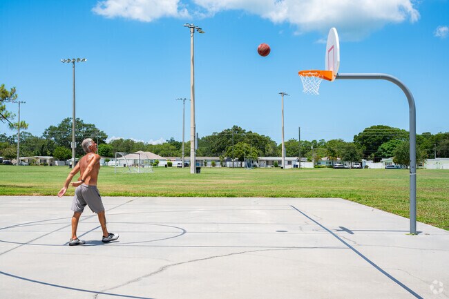 Locals enjoy the basketball court and open sports fields at Azalea Park.