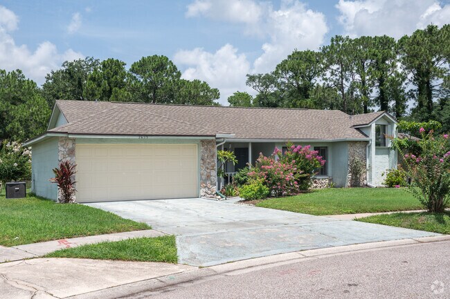 Colorful pink flowers brighten up this adorable ranch home in Peppermill.