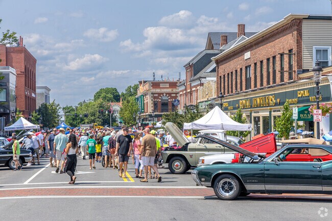 People walk up and down Main St at The New England Summer Classic Car Show in Andover, MA.