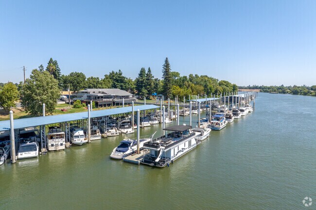 A marina, along the Sacramento River, in the Southport houses many style of boats.