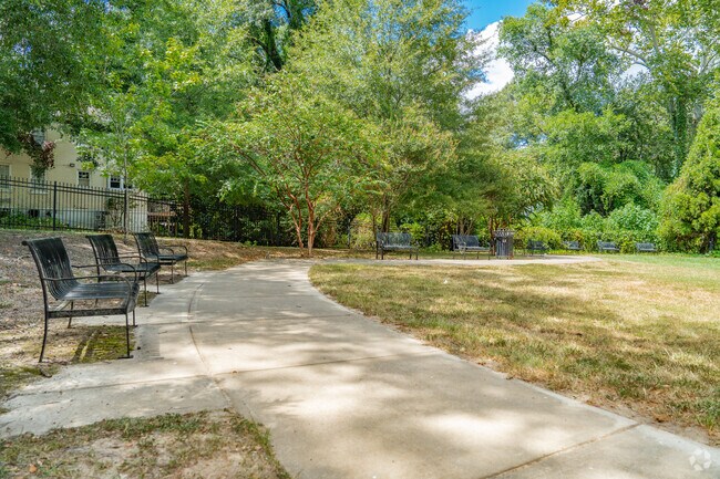 Belhaven Park is a quaint neighborhood park with benches and a small stage.