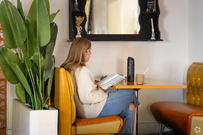 Enjoying a good book with coffee at Grounded Café, a cozy spot near Mesilla Park.