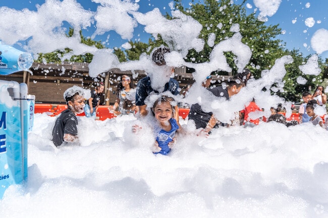 Kids get blasted with soap suds at the Juneteenth Celebration in Central Lancaster.