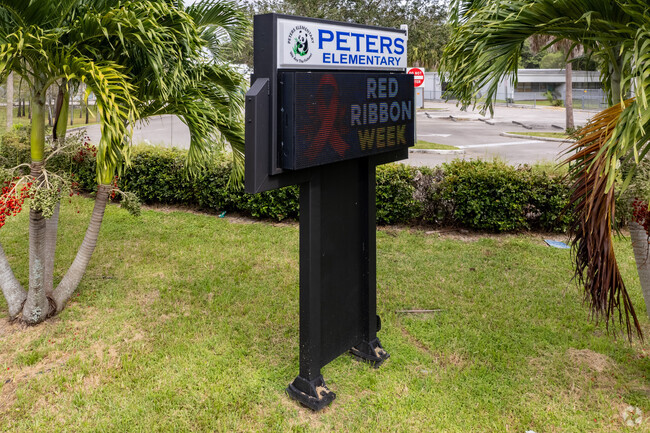 School updates are shown on the school sign of Peters Elementary School in Plantation, FL.