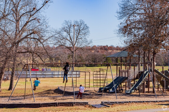 Children enjoying playing the swing of Wildhorse Park.
