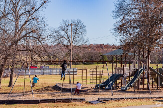 Children enjoying playing the swing of Wildhorse Park.