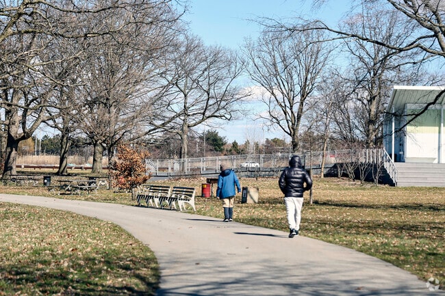 Residents of Westchester Square walk on a beautiful day.
