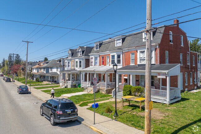 Covered front porches sit on the bottom level of 3 story row homes next to duplexes in Southwest York.