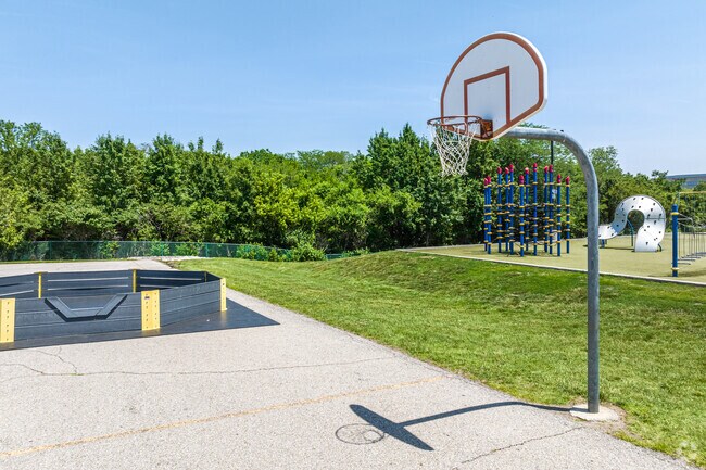 At Heartland Elementary School there is a basketball court and a play area for the kids.