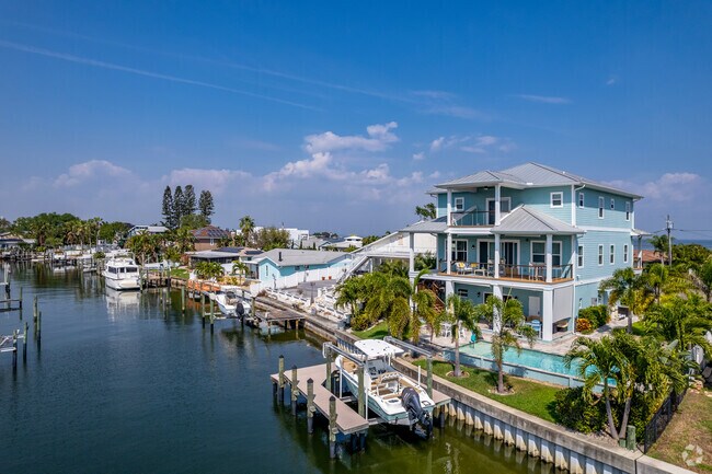 Coastal-style homes on the water have private boat docks in the Coquina Key.