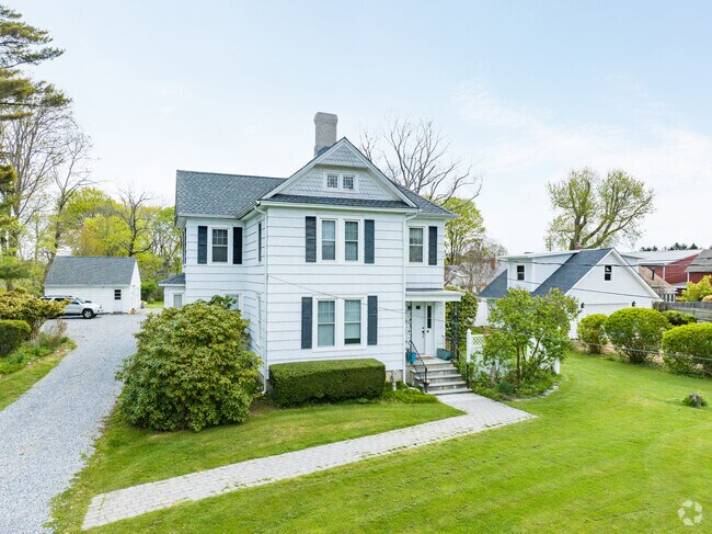 Stick Hipped Roof style home home with a detached garage in the backyard in Southolds North Fork.