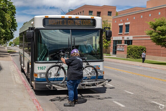 A resident secures their bike to the bus in Hillcrest.