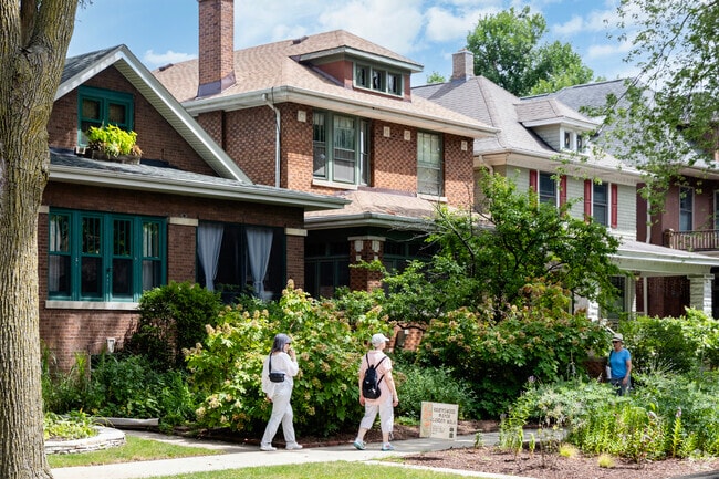 Ravenswood Manor residents stroll past the large cottages and vibrant font yard scapes.