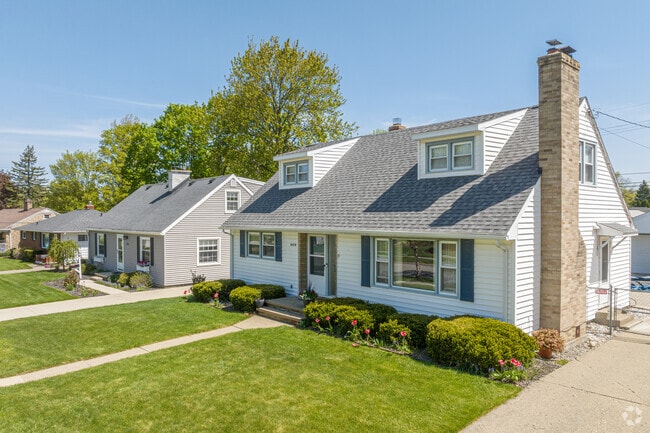 Cape Cod-style houses in Averill Woods, Lansing, feature spacious yards and driveways.