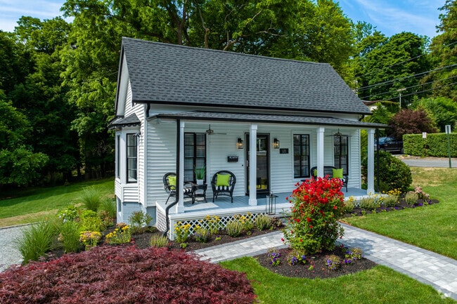 Cute little Cape Cod homes have beautiful front lawns in the Port Jefferson region in New York.
