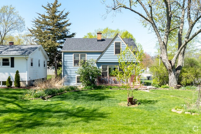 Located in W. Wheaton is Cape Cod style home with blue siding and quaint front porch.