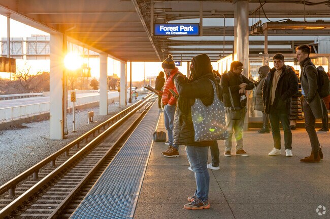 As the sun sets over Rosemont eager passangers wait to board the CTA Blue line.