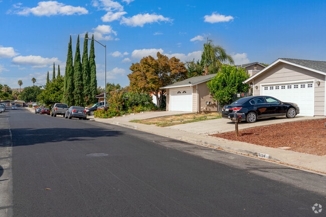Homes with attached garages are found along tree-lined streets in Bay Point West.