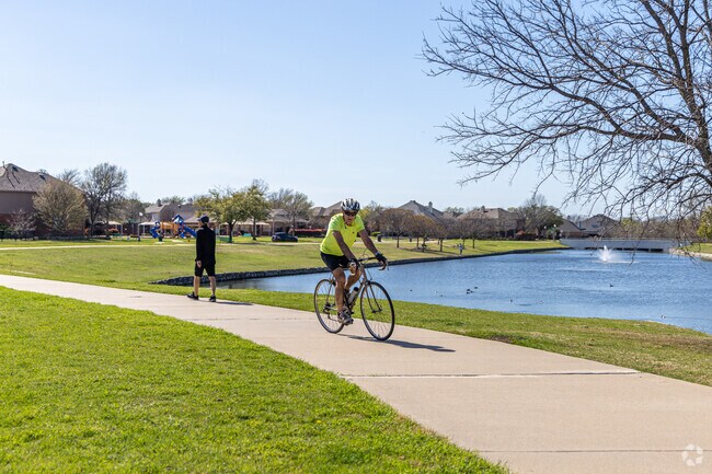 Residents of Spring Ridge go cycling on Legacy Trail with water views.