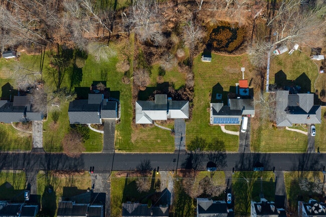 Some homes in Long Hill have large lots and many trees.