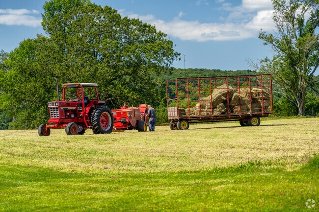 A farmer adjusts his tractor at a farm in Sprague.
