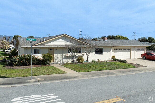 A classic ranch-style home in Watsonville with a sprawling front yard and simple elegance.