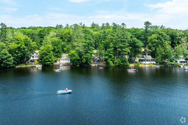 A boater enjoying the Upper Suncook Lake alongside a row of lakeside homes in Barnstead, NH.