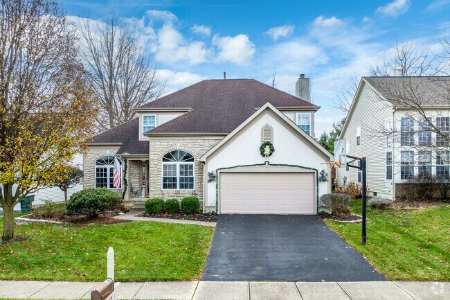 A two story home in Worthington Crossing features beautiful landscaping.