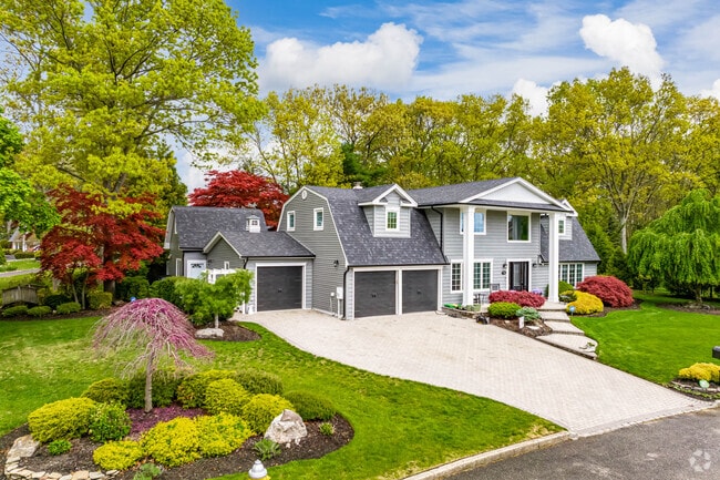 This modern colonial in Commack encompasses several styles including a gambrel roof.