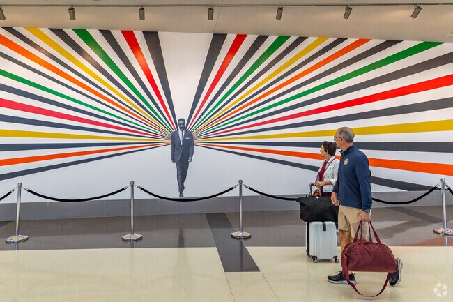 Arriving passengers at Birmingham airport view the Rev. Fred Shuttlesworth mural in Zion City.
