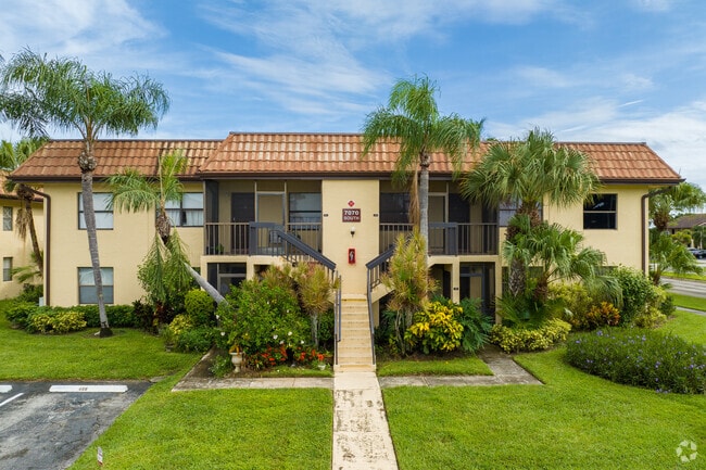 Smaller condominiums in Lucerne Lakes are often surrounded by palm trees and gardens.