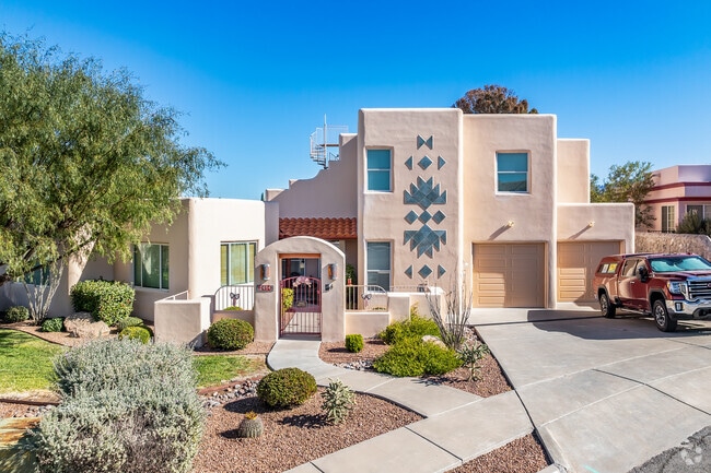 This pueblo revival home is a 2-story version with a beautifully landscaped yard in High Range.
