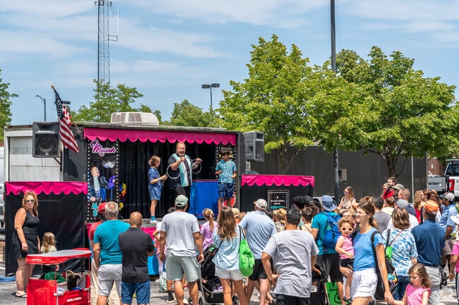 A magician does magic tricks during Play, Picnic & Party in Elk Grove Village East.