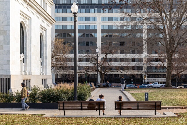 Locals can sit on benches located outside of the Carnegie Library in Mount Vernon Square.