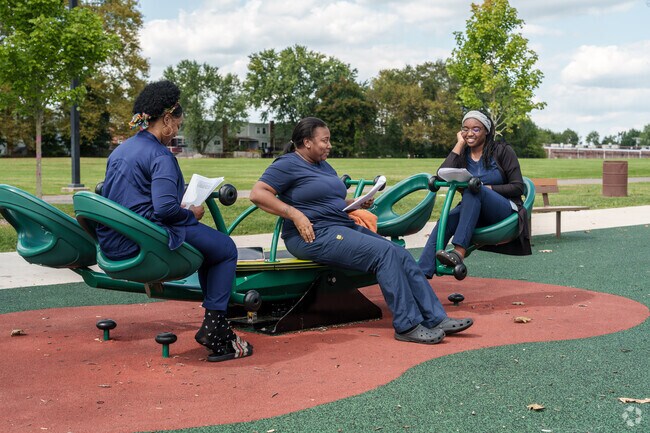 Three Widener University nursing students study at the Upland Park playground.
