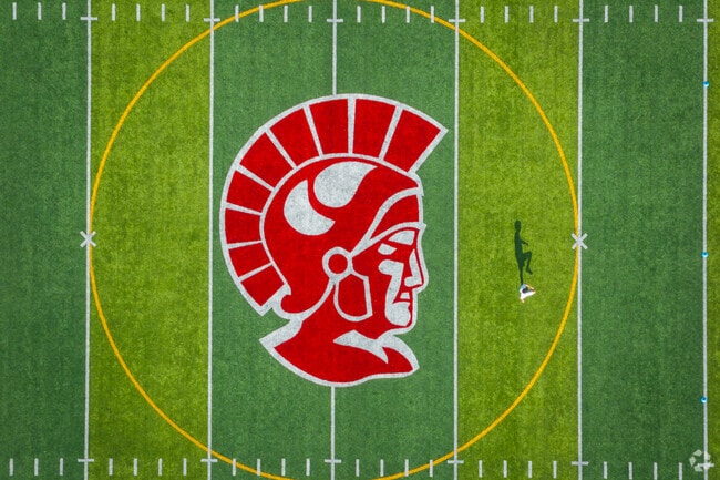 This Trojan soccer player gets loose before the game at Monroe High School.