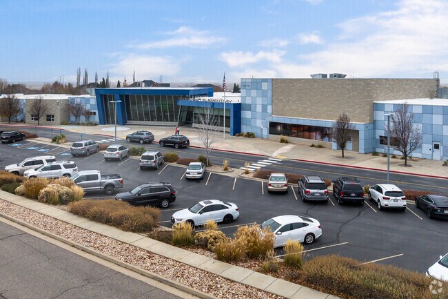 A mother walks with her child near the entrance of Endeavor Elementary School in West Kaysville.