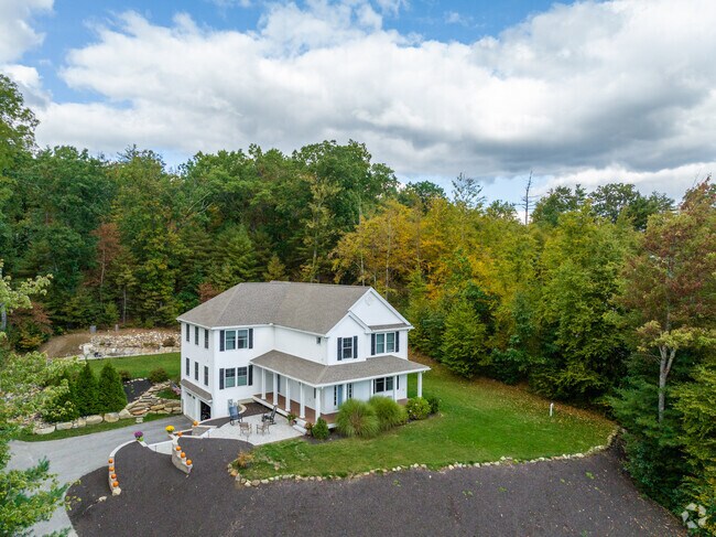 In Hollis, you can find new builds such as this home, offering large layouts on wooded lots.