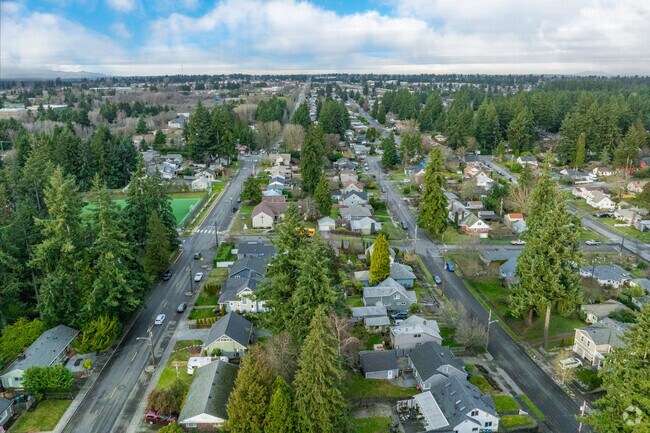 Residential streets in Fircrest are nestled among greenery and large fir trees.