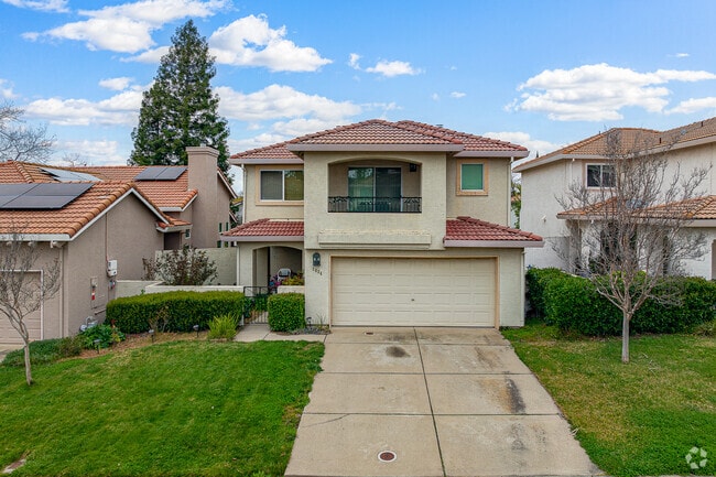 Two story home with prestine lawn sits peacefully in Stanford Ranch.