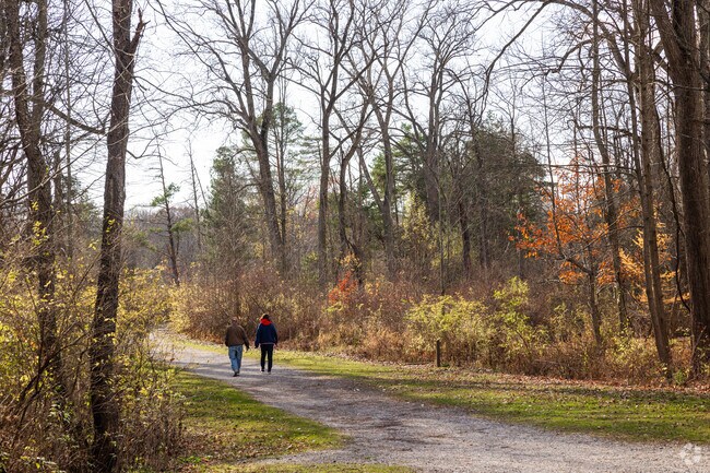 A couple walks along a scenic path in Reinstein Woods Nature Preserve.