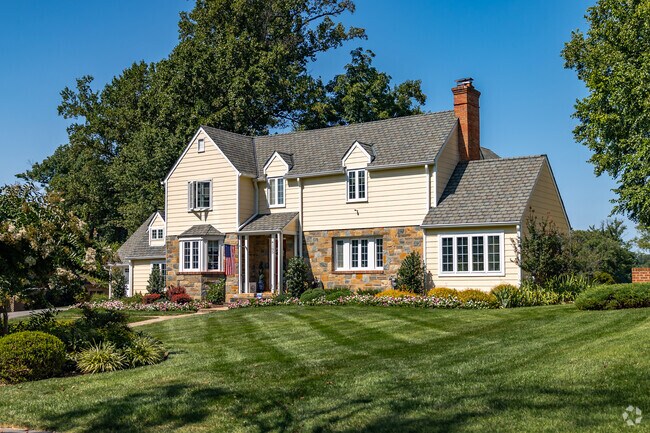 An enchanting tudor revival home with pristine landscaping in Manor Park.