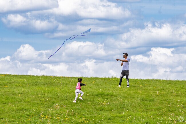 A dad and his daughter fly a kite in Dorais Park, a large park near Nortown.